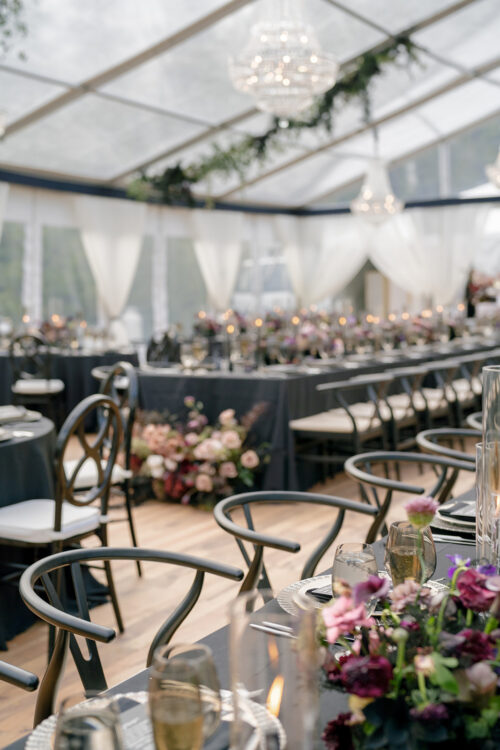 Moody floral wedding tablescape under a clear-top tent in the Berkshires