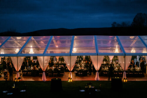 Evening tent glow with candlelight and uplighting in the Berkshires
