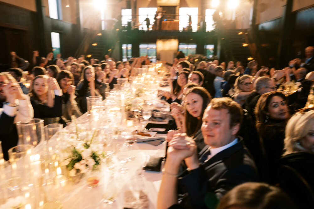 Guests enjoying a multi-course family-style dinner at Kingdom of the Hawk wedding reception.