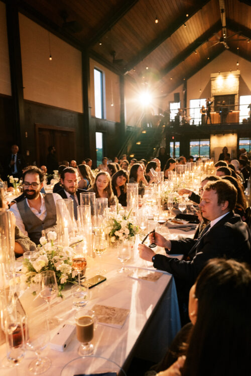 Guests enjoying a multi-course family-style dinner at Kingdom of the Hawk wedding reception.