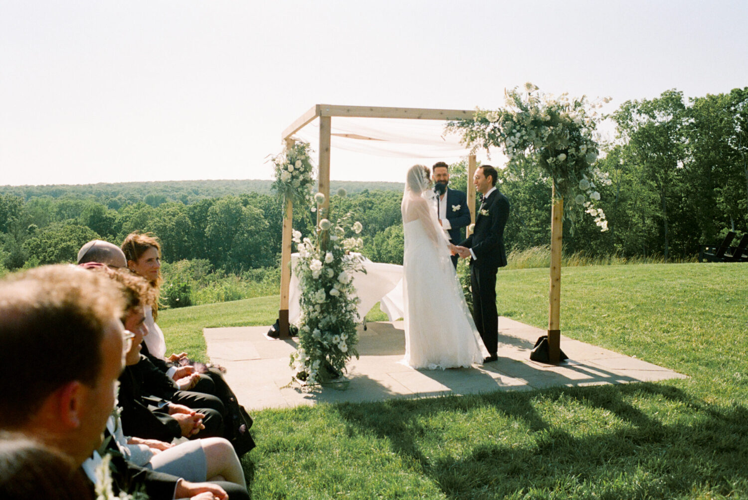 Bride and groom exchange vows at Kingdom of the Hawk wedding ceremony in Connecticut vineyard.