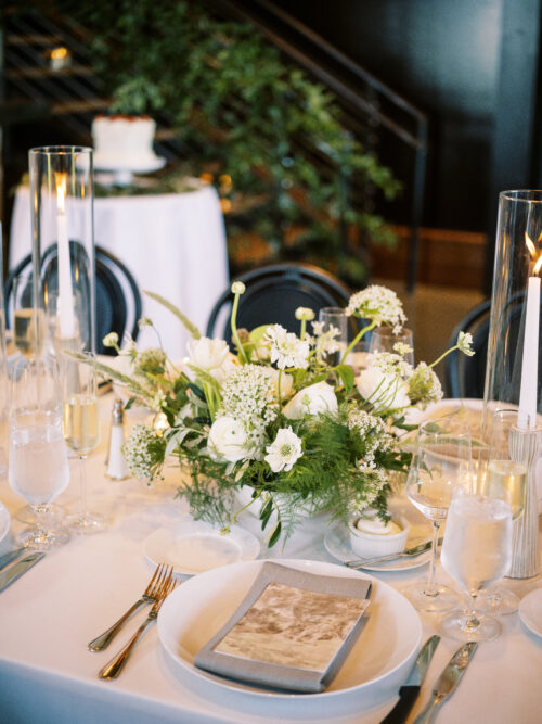 Reception tables with elegant place settings at Kingdom of the Hawk wedding.