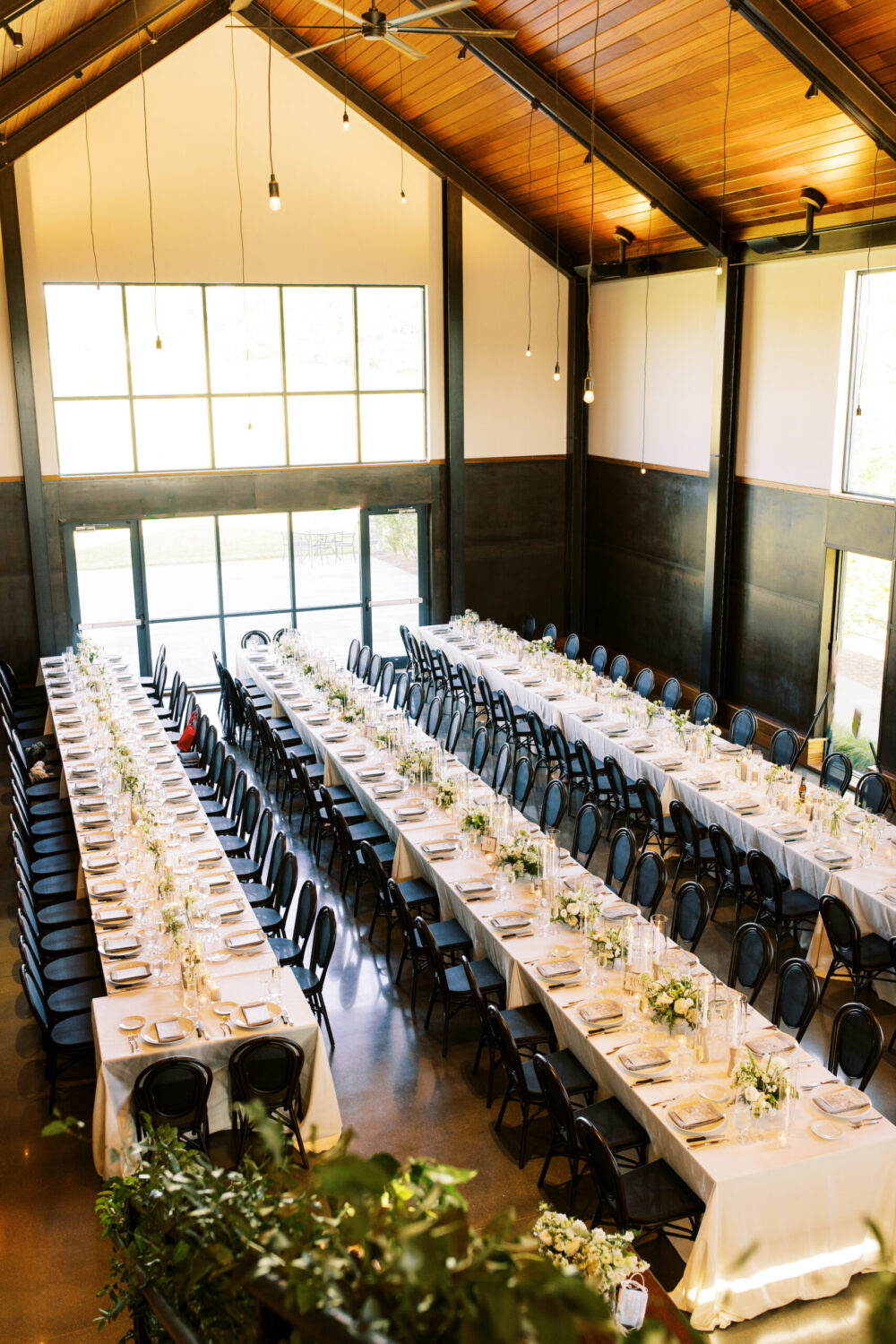 Reception tables with elegant place settings at Kingdom of the Hawk wedding.